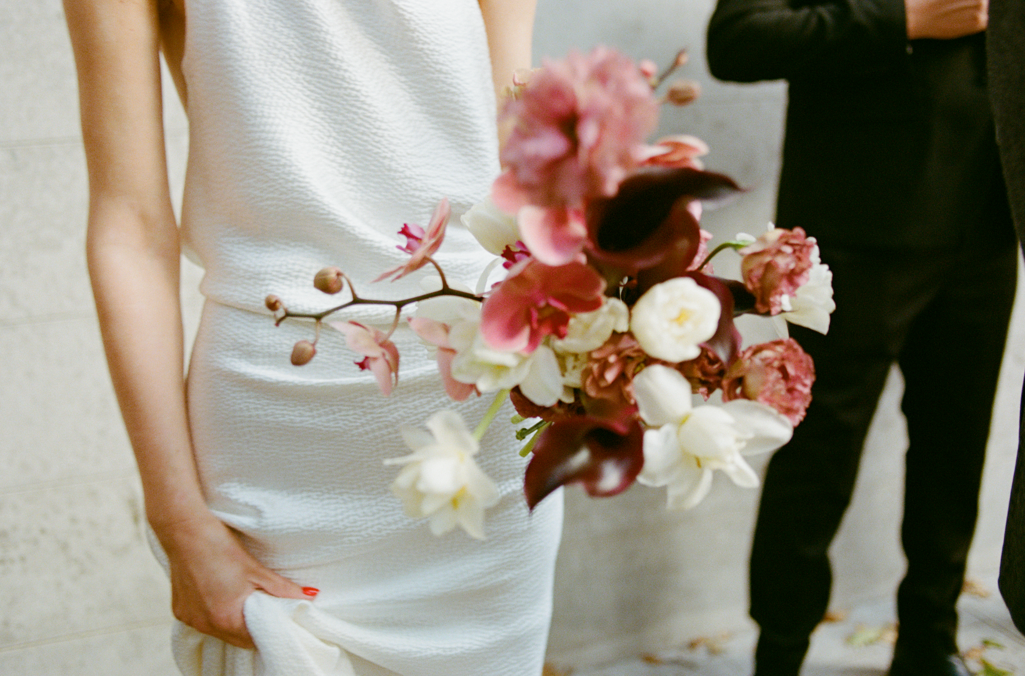 Person holding a bouquet of flowers with a blurred background